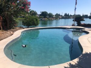 Level 2 pool and spa, 4' radius spa with negative edge, 22,000 gallon pool, Tahoe blue mini pebble. This pool was completed in 35 days.